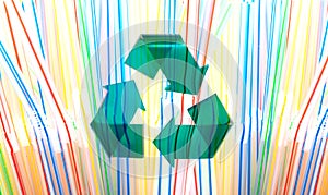 Green Stylish Recycle Arrow on Multicolored Plastic Straws Background. Reuse Sign. Environment Care Concept