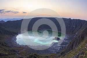 Green sulfuric lake in volcanic crater photo