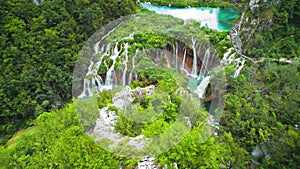 Green summer forest in Plitvice Lakes National Park in Croatia. Mountain waterfall flows with many streams of crystal