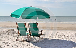 Green sun chairs and umbrella