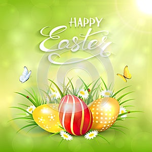 Green sunny background with Easter eggs in grass