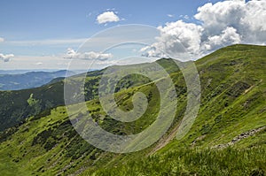 Green sunny hills and mountains. Travel concept. Carpathian mountains in summer. Beauty of nature. Hiking destination.