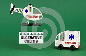 On a green surface, an ambulance car and a helicopter with a sign - ULCERATIVE COLITIS