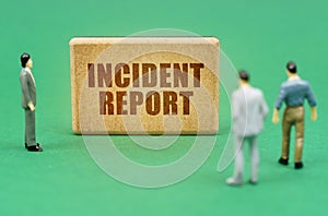 On the green surface are figures of people and a sign with the inscription - Incident report