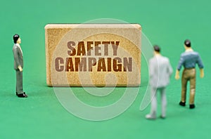 On the green surface are figures of people and a sign with the inscription - Safety Campaign