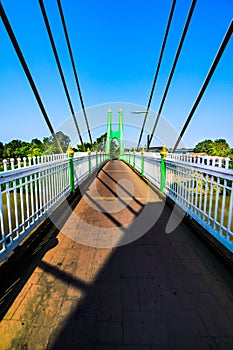 Green suspension bridge across Nan River at Chum Saeng District