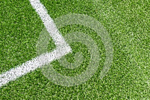 Green synthetic artificial grass soccer sports field with white corner stripe line