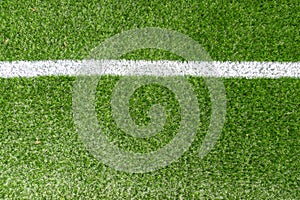 Green synthetic artificial grass soccer sports field with white corner stripe line