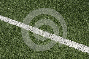 Green synthetic artificial grass soccer sports field with white line