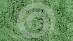 Green synthetic carpet with small holes