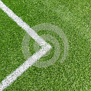 Green synthetic grass soccer sports field with white corner stripe line