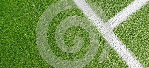 Green synthetic grass soccer sports field with white stripe line