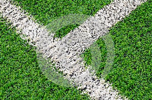 Green synthetic grass sports field with white line