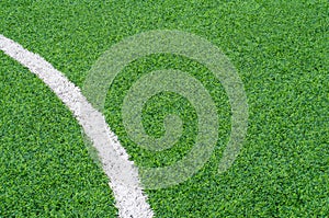 Green synthetic grass sports field with white line