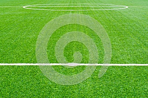 Green synthetic grass sports field with white line