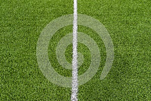 Green synthetic grass sports field with white line shot from above. Soccer, rugby, football, baseball sport concept