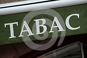 green tabacco store front with french text tabac, the photo
