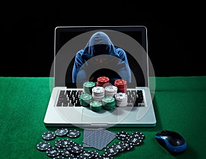 Green table with casino chips and cards on notebook