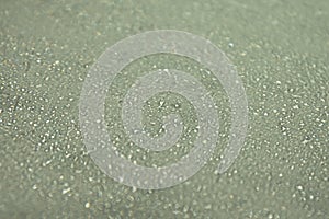 Green table surface with water drops