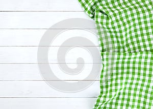 Green tablecloth on white wood table