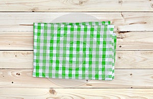 Green tablecloth on wooden table, top view