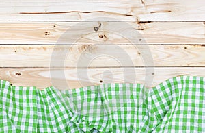 Green tablecloth on wooden table, top view