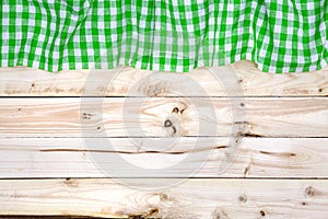 Green tablecloth on wooden table, top view