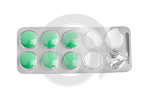 Green tablets in a blister pack. Opened packaging. isolated on white background