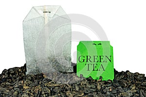 Green tea Bag on dry leaves isolated on white - Gunpowder tea