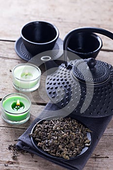 Green tea in bowl and traditional asian tea set