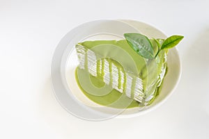 Green tea cage with greentea leaf on white plate