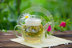 Green tea with chamomile in cup photo