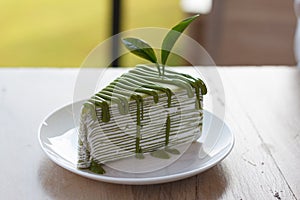 Green tea crepe cake topping with green sauce
