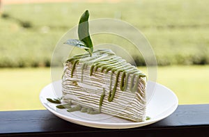 Green tea crepe cake on white disk