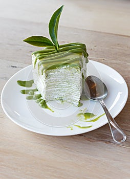 Green tea crepe cake on white disk