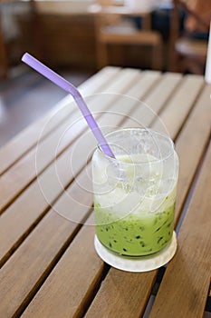 Green tea drink of cold milk on table.