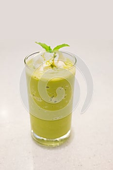 Green tea frappe, topping with peppermint leaf.