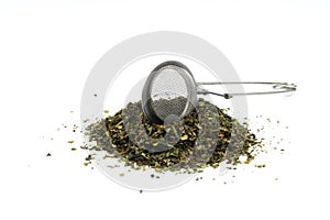 Green tea with herbs in sieve on a White Background