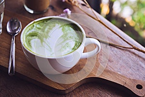 Green tea hot drink latte white cup on wood table aroma relax ti