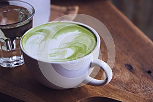 Green tea hot drink latte white cup on wood table aroma relax ti