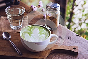 Green tea hot drink latte white cup on wood table aroma relax time in coffee shop