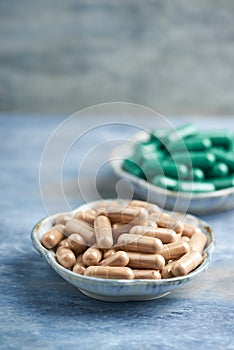 Green Tea and L - Carnitine capsules. Concept for a healthy dietary supplementation.