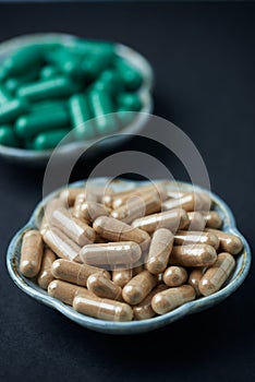 Green Tea and L - Carnitine capsules. Concept for a healthy dietary supplementation.