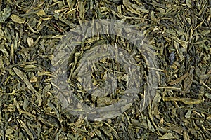 Green tea leaflets, detail, macro, full frame, horizontal texture. Green Tea. Sencha.