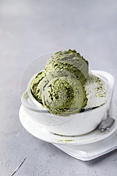 Green Tea Matcha and Coconut Ice Cream in White Bowl on a Grey Background Tasty Healthy Vegan Ice Cream Vertical