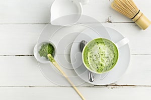 Green tea matcha latte cup on white background from above flat v
