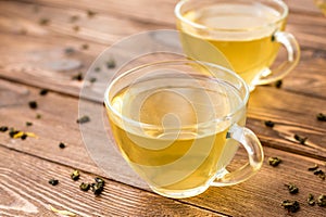 Green tea with mint, rose, goji berries and pineapple in cups