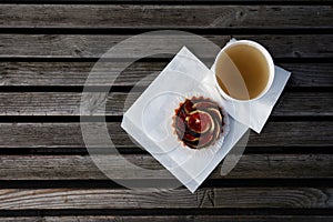 Green tea in a paper bucket and tartlet with figs