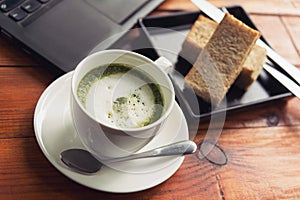 Green tea is served with hot bread between the notebook.