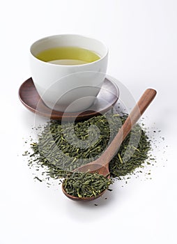 Green tea and tea leaves on a white background